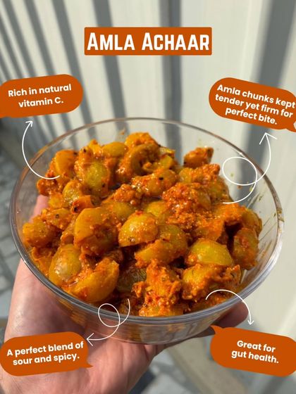 A close-up of our Amla Achaar, rich in natural vitamin C. The amla chunks are tender yet firm, offering a perfect blend of sour and spicy that's also great for gut health.