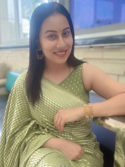 A close-up of Dr. Shruthi, her smile as bright as her beautiful, modern-style saree.