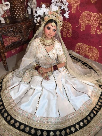 Two shots of a model in a white lehenga, showcasing a beautiful gold and kundan choker set. The jewellery provides a traditional contrast to the modern lehenga.