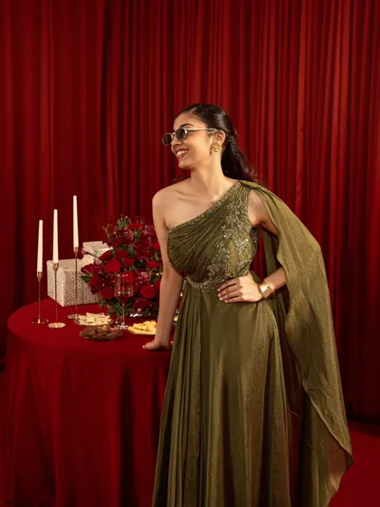 A fun, celebratory shot for a festive collection. The model's candid smile and the party-themed props create a lively and relatable atmosphere, showcasing the dress in a dynamic way.