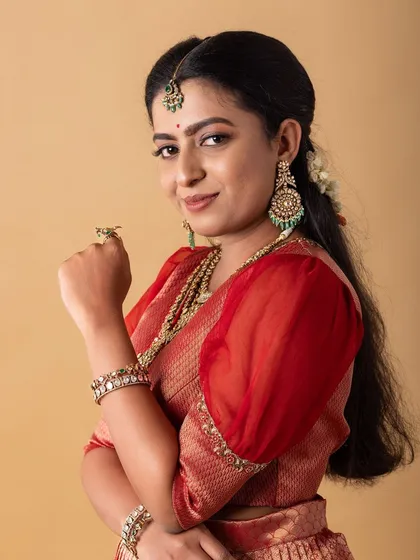 A portrait from a collaborative photoshoot. The makeup is fresh and radiant, giving the model a youthful glow that complements the traditional attire.