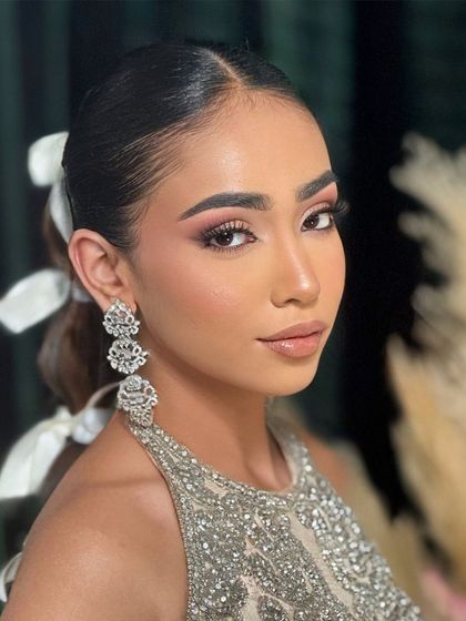 The model's close-up, showing how the sleek front of the hair balances the voluminous braid.