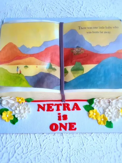 A top-down view of the hand-painted storybook cake.