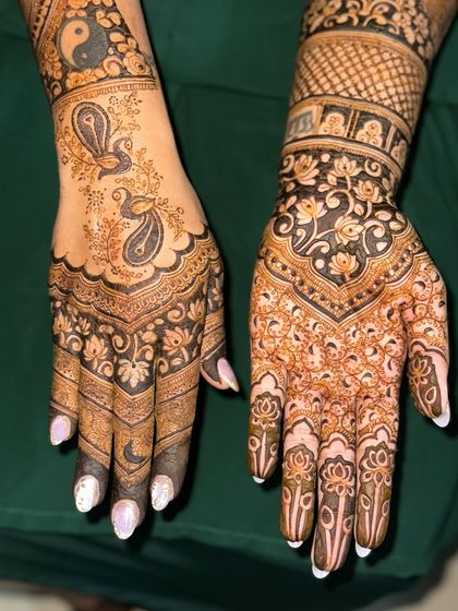 The palms of the hands, featuring a mix of peacocks, yin-yang symbols, and floral patterns.