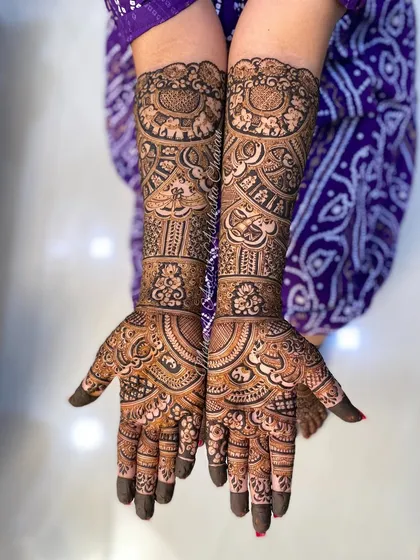 A beautiful bridal mehendi for a happy client. The design is a mix of peacocks, paisleys, and other traditional Indian motifs, creating a full and festive look.