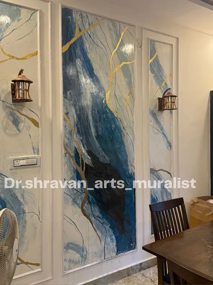 This blue and white abstract mural is another take on the granite style, created within decorative wall panels. The gold accents catch the light, adding a touch of warmth to the cool tones.