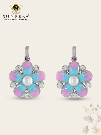 These charming silver earrings feature a flower design with vibrant pink and blue enamel and a pearl center. They are a playful and colourful addition to our silver collection.