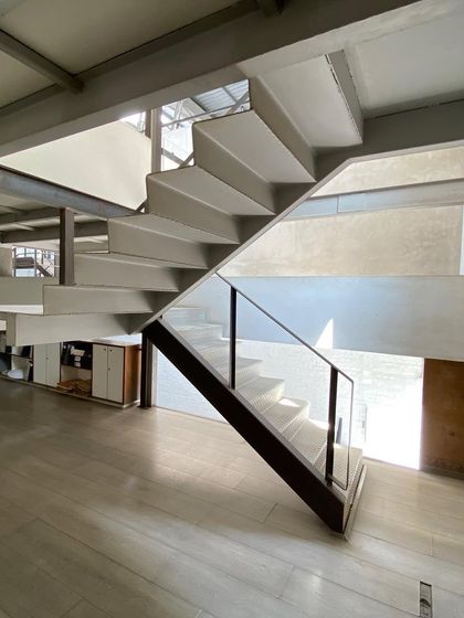 A different view of the staircase at Zanav Home, showing how it connects different levels of the open-plan studio.