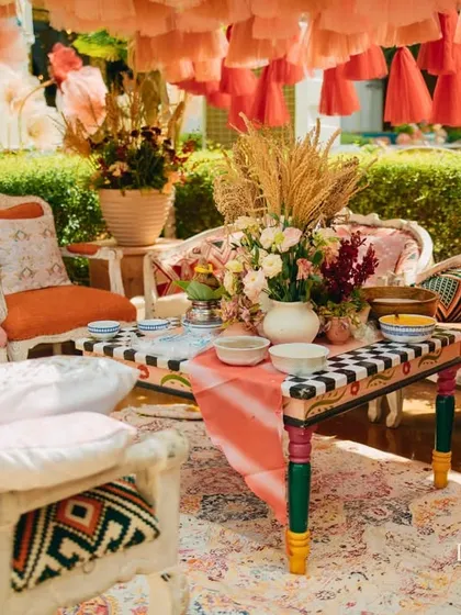 A close-up of the hand-painted and custom-upholstered furniture used in the royal Mehendi tent. I source or create bespoke pieces to ensure every event is truly one-of-a-kind.