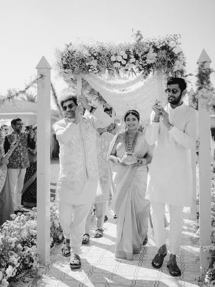 A classic black and white photograph of the bride's entrance, emphasizing the emotion and tradition of the moment.