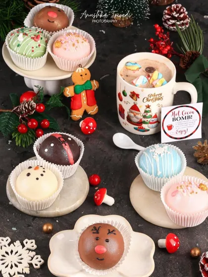 The hot cocoa bombs ready to be dropped into a warm mug of milk. This shot creates a sense of anticipation and cozy comfort.