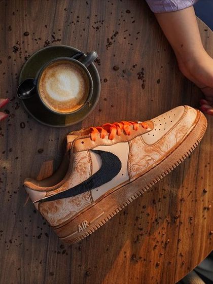A perfect pairing: a fresh cappuccino and a freshly customized pair of coffee-dyed sneakers. This shot captures the essence of my collaboration with Grounded Cafe, combining the aroma of coffee with wearable art.