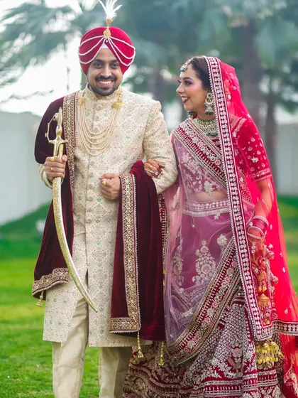 A candid moment of pure happiness between a beautiful Sikh couple. We believe the best shots are the unposed ones, capturing the genuine smiles and laughter that make your wedding day unique. This photo reflects our classic and vibrant wedding photography style.