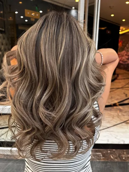 The back view of this ash blond balayage, showing the intricate blend of ashy and brown tones.
