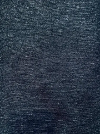 A subtly faded dark denim. This fabric provides a softer look than raw denim while still maintaining a deep blue color.