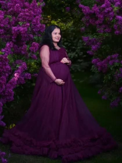 A fairytale moment for a mother-to-be. This outdoor portrait showcases one of the elegant maternity gowns I provide, set against a stunning backdrop of purple flowers to create a vibrant and dreamy image.