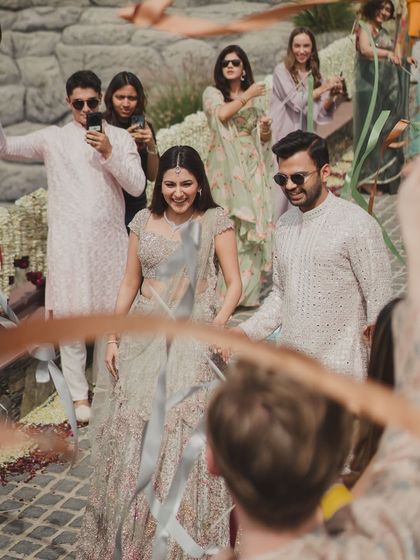 A candid, happy moment of the couple during their ribbon entry, surrounded by friends and family.