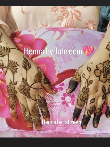A lovely pair of hands showing two different but complementary minimal designs. One is a floral vine, and the other is a more abstract leafy pattern, showing how guests can choose different styles.
