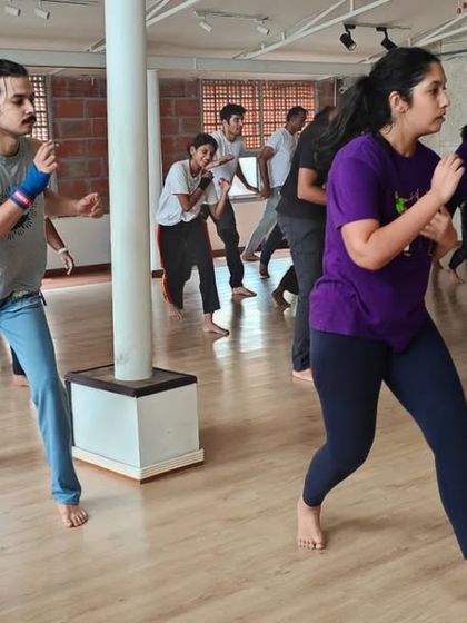 A still from a Batizado workshop, capturing the focused intensity of our students as they practice their ginga. Everyone is in the zone, learning and moving together.
