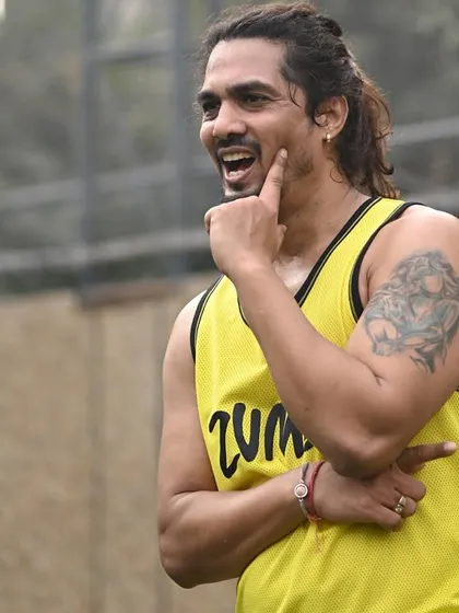 Our lead instructor, Aryan, engages with the crowd during an outdoor Zumba session. His energy and enthusiasm are key to making our corporate wellness events a success.