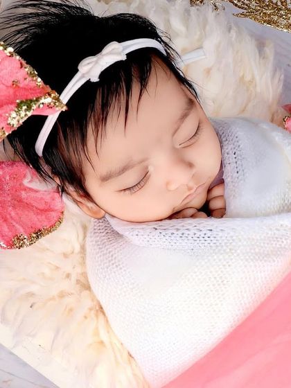 A tight close-up, focusing on the baby's peaceful expression.