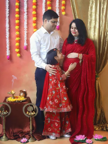 A complete family portrait, filled with love and anticipation. Capturing the whole family in traditional attire makes the moment feel so special and celebratory.