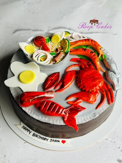 This might look like a seafood platter, but it's a 100% eggless cake. I enjoy surprising my clients with hyper-realistic designs where every element, from the crab and prawns to the fried egg, is completely edible and delicious.