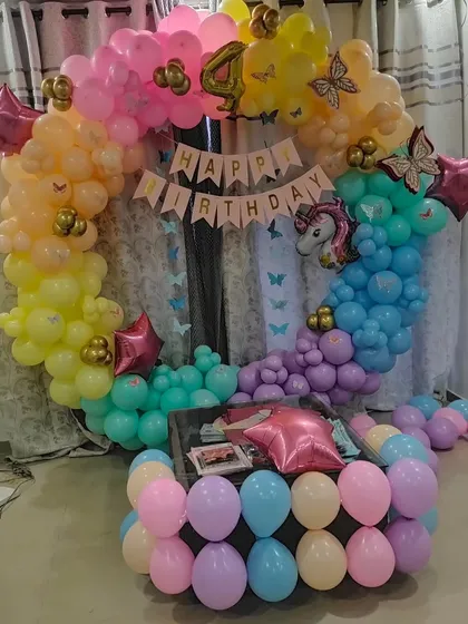 The full view of the rainbow unicorn balloon arch, designed to create a magical photo corner at home.
