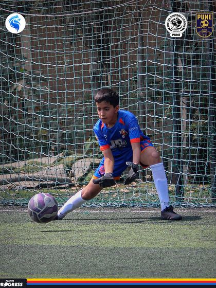 A goalkeeper in Pune gets down quickly to make a save. Strong goalkeeping is the backbone of any successful team.
