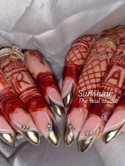 Elegant chrome French tips for a bride. The gold chrome adds a modern touch to the classic French manicure, perfectly matching the beautiful henna design.