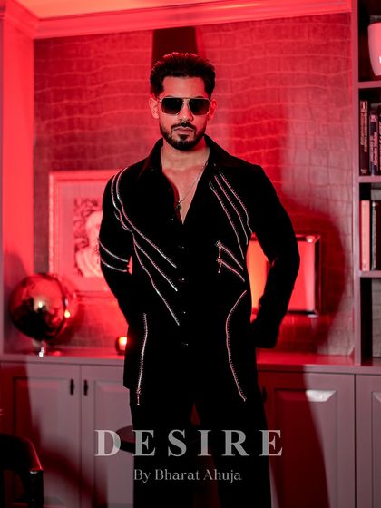 A powerful, full-length shot of the zipper-detailed shirt in a luxurious, red-lit room. This is elegance with an edge.
