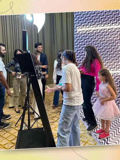 A behind-the-scenes look at our photo booth setup at Tots Couture Week. Our host is seen here guiding guests to ensure they get the perfect shot.
