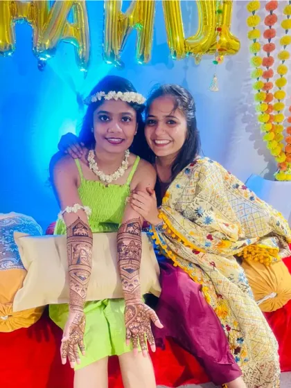 A bride posing with her friend during her mehndi ceremony. It's always fun to share these moments with your loved ones.
