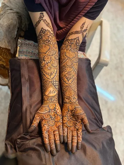 Both arms of the bride, showcasing the full, detailed design.