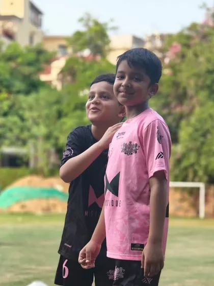 Friendship and football go hand in hand. Two young players share a smile during a break in training at our NFC centre.
