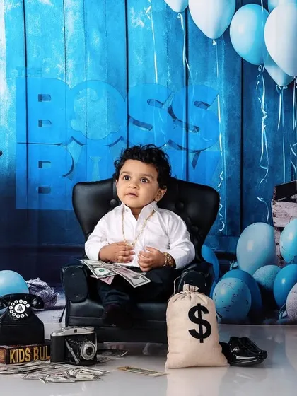 Who's the boss? This little guy is, in our popular Boss Baby themed setup. Complete with a tiny suit, a bag of money, and a mini-throne, it's a fun and playful way to capture your baby's big personality.