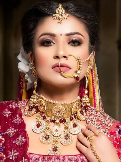 A classic bridal look with a red and gold jewellery set, perfect for makeup students practicing traditional bridal makeup.