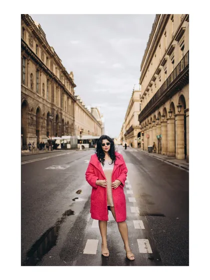 A bold and stylish portrait on a Parisian street. This shot highlights the bride-to-be's personality, adding a touch of fashion-forward flair to their pre-wedding album.