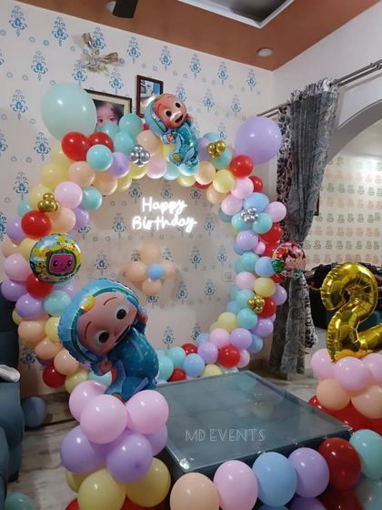 Another view of the Cocomelon themed home party, showing how the circular balloon arch fits perfectly around a small table.