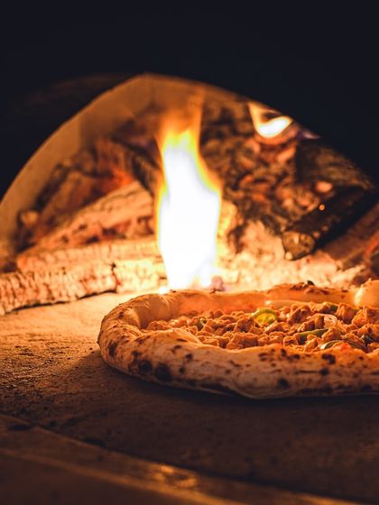Our Neapolitan pizza isn't just cooking in the wood-fired oven, it's turning up the heat!