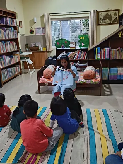 A storyteller uses a string of paper dolls to narrate a Julia Donaldson classic, a favorite author at our library.