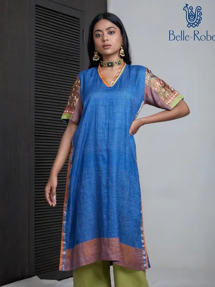 A full-length shot for Belle Robe. The makeup is natural and fresh, ensuring the model looks polished while keeping the focus on the colorful and comfortable ethnic wear.
