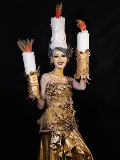 A smiling pose from the candle character, showing that even the most elaborate makeup can allow for expression and movement.