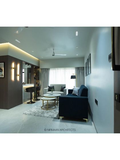 This wide shot of the Tulsi Heights living room shows how we created an open, continuous space for living and dining. The clean lines and neutral palette are punctuated by a bold navy sofa.