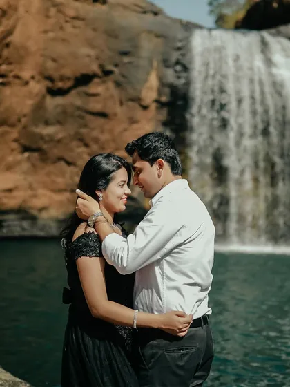A beautiful portrait of the couple embracing in front of a waterfall. The natural backdrop enhances the romance of this pre-wedding photograph.