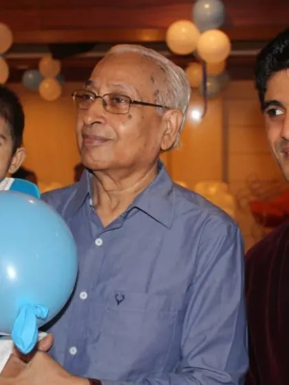 A candid shot with the birthday boy and his grandfather. These multi-generational moments are what make family events so special.