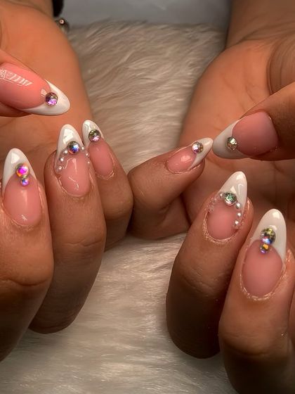 Classy never goes out of style. This is a beautiful example of a classic French manicure, elevated with sparkling crystal placements for a touch of glam.