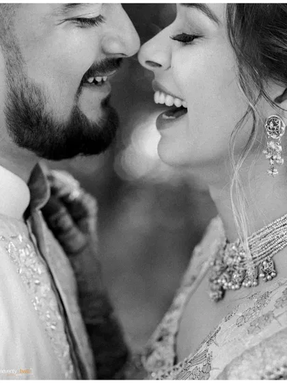 A close-up of pure, uninhibited laughter. This black and white shot captures the sound and feeling of joy, a perfect candid moment from their haldi ceremony.