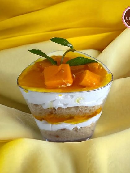 My Mango Dessert Cup is a delightful single-serving treat. It features layers of light sponge, creamy filling, and a topping of fresh mango puree and chunks, perfect for enjoying the season's best flavor.