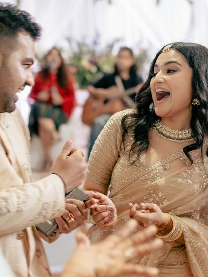 A candid, interactive moment between the couple during their engagement party, full of expression and life.